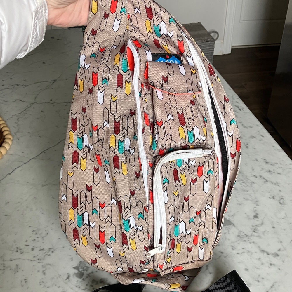 Kavu Sling Bag in Tan with Red, Yellow, Teal & White Arrow Print